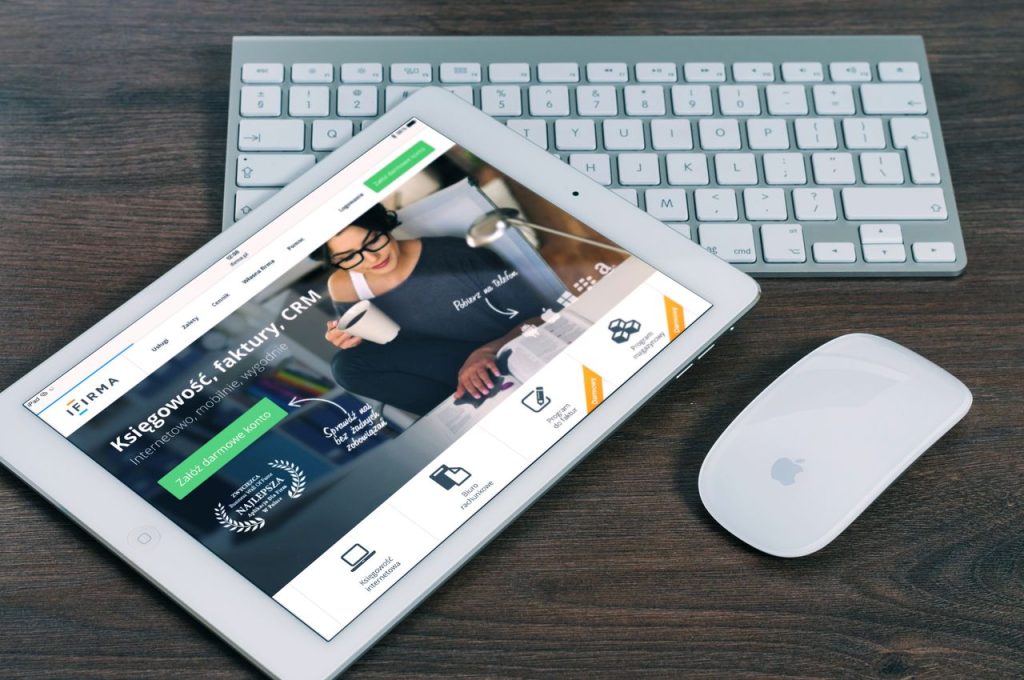 ipad mockup apple business 39559 39559 A tablet with a financial website open, alongside a white keyboard and mouse. Ideal for tech-theme stock images.
