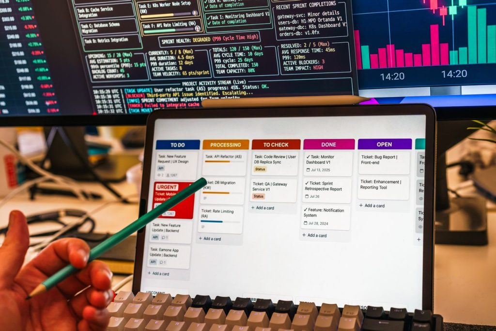 pexels photo 38984817 38984817 Detailed view of a business workflow setup with tablet and multiple screens displaying data charts.