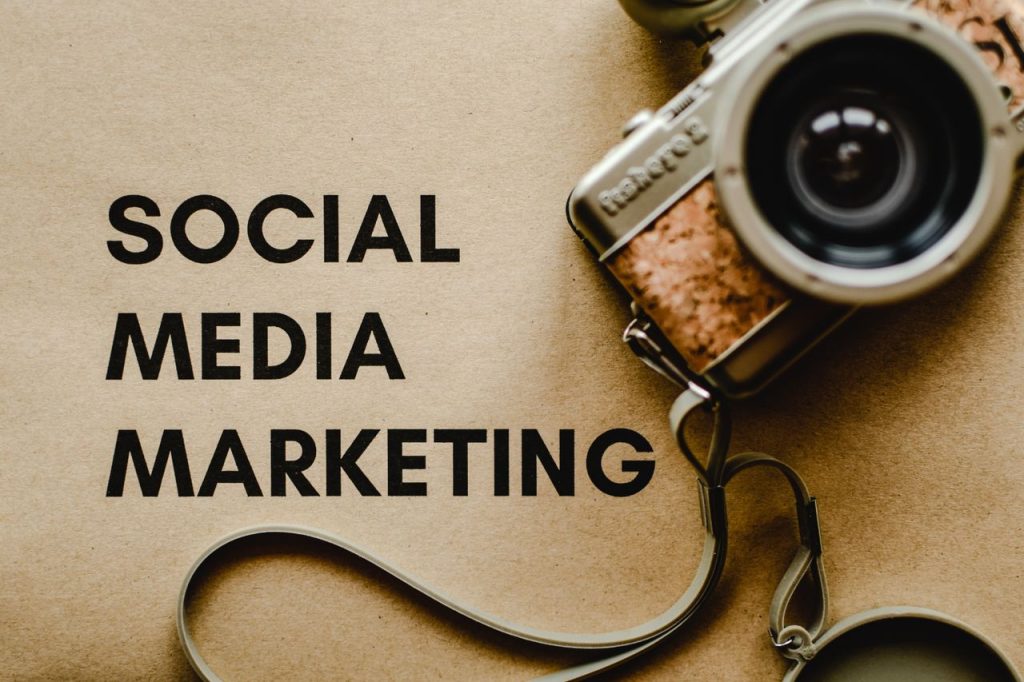 pexels photo 6956301 6956301 A vintage camera on brown paper with 'SOCIAL MEDIA MARKETING' text, perfect for marketing visuals.
